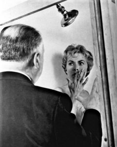 Alfred Hitchcock directing a suspense scene on set