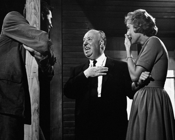 Anthony Perkins, Alfred Hitchcock, and Janet Leigh laughing on the set of Psycho