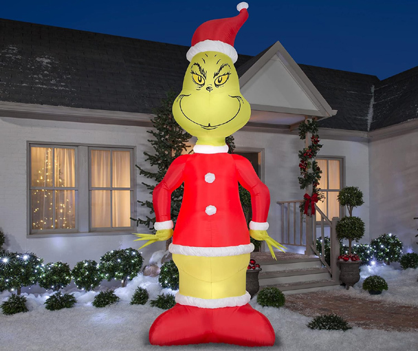 Grinch inflatable displayed outdoors with holiday lights