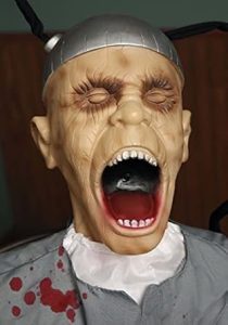 Screaming face of Death Row Animatronic with glowing red eyes and twisted expression