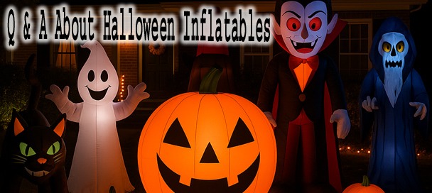 Halloween Inflatables glowing in a decorated front yard at night
