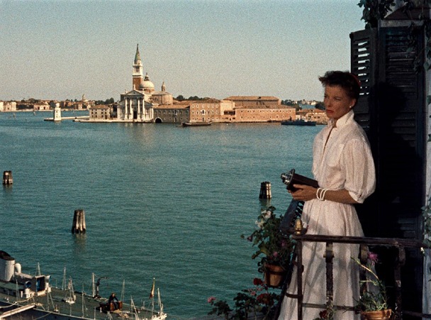 Katharine Hepburn in a white dress by the water in Summertime (1955)