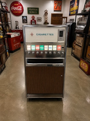Restored vintage vending machines displayed in a private collection room alongside other mid-century Americana