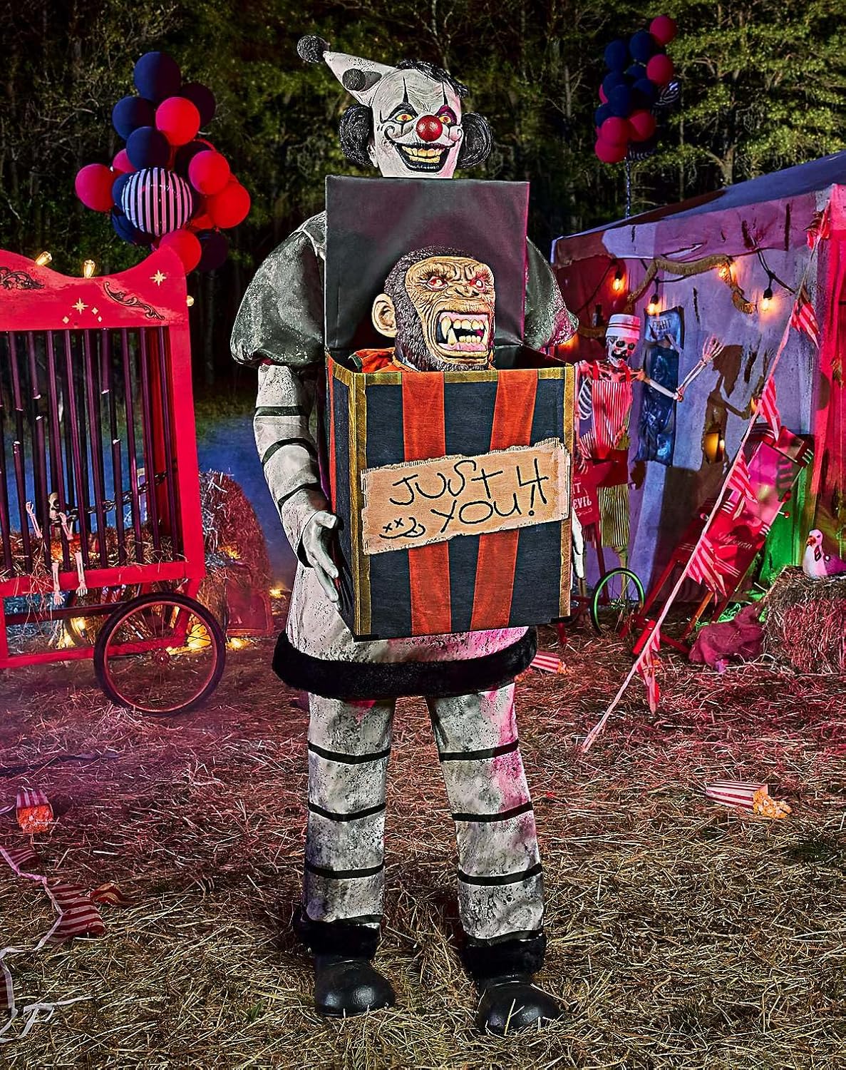 Monkey Business Clown Animatronic in darkened Halloween display with gift box open and monkey revealed