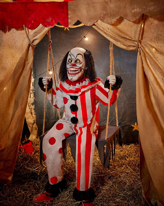 Toothy the Clown Animatronic displayed on stair step in Halloween haunted house setting