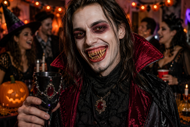 DIY Fake Teeth worn with a creepy vampire costume at a Halloween party, showing the finished custom horror smile.