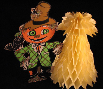 Vintage Halloween Collectibles featuring a classic die-cut pumpkin figure with a honeycomb tissue corn, a popular Halloween decoration from the early twentieth century.