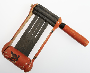Vintage Halloween Collectibles featuring a classic Halloween ratchet noisemaker with colorful lithographed artwork from the mid-twentieth century.
