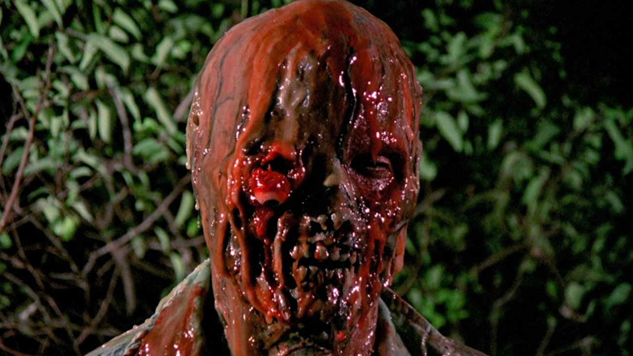 The Incredible Melting Man Review featuring a close-up of Rick Baker's gruesome melting-face makeup effects from the 1977 horror film.
